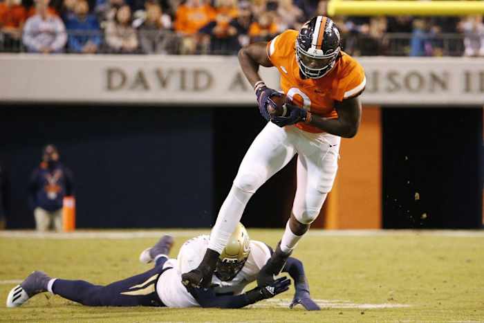 Oct 23, 2021; Charlottesville, Virginia, USA; Virginia Cavaliers tight end Jelani Woods (0) runs with the ball past Georgia Tech Yellow Jackets defensive back Tariq Carpenter (2) during the third quarter at Scott Stadium.